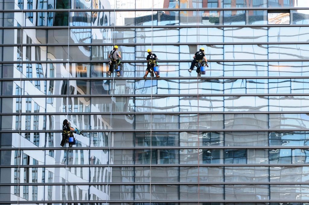 Professional cleaner at work on a high-rise building