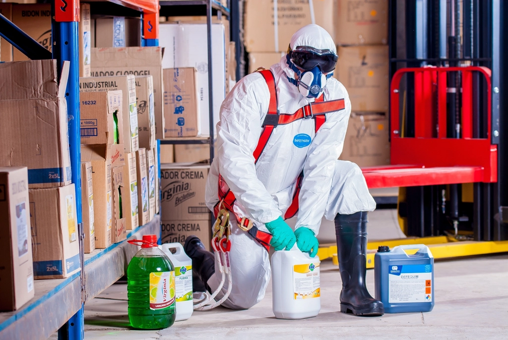 Cleaning staff in protective gear preparing supplies